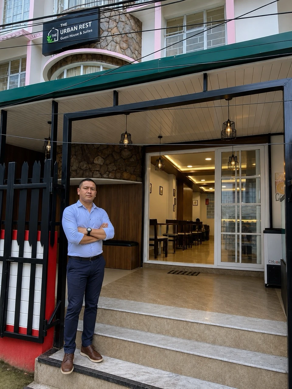 The owner of The Urban Rest Guest House and Suites, Mr. Abhijit B Jyrwa, standing in front of the property